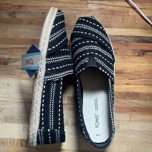 BRAND NEW never worn TOMS. Size 9 black with white and tan bottoms
